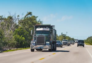 A construction truck driving on a Florida highway.