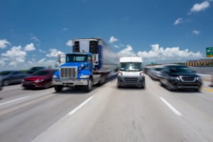 Delivery trucks speeding on a Florida highway.