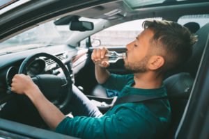 A man drinking while driving.