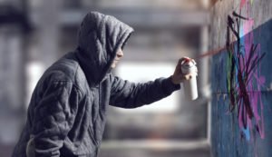 A man spraypainting a wall