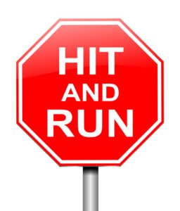A stop sign with the words “Hit and Run” on it