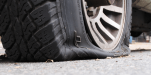 A truck with a burst tire.