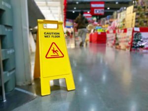 A wet floor sign in a store.