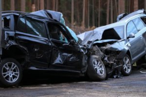 Two cars damaged from a head-on collision