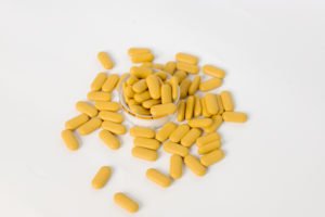 A pile of pills on a table.