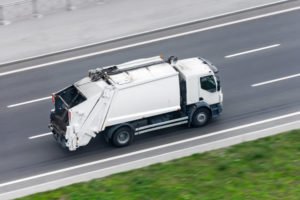 white-garbage-truck-on-highway
