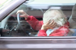 elderly driver asleep at the wheel
