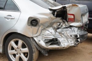 A silver car with rear-end-damage