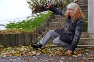 older woman falling down stone steps