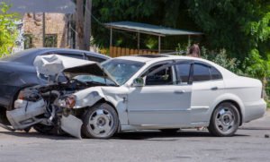 white car messed-up in an accident
