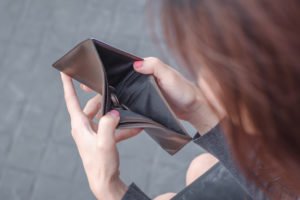 woman opening empty wallet