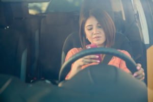 woman texting while driving