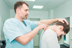 neurologist examining a patient’s spine