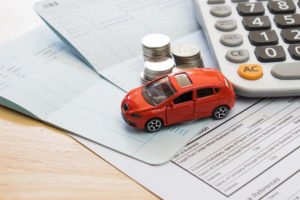 toy car with insurance papers and coins
