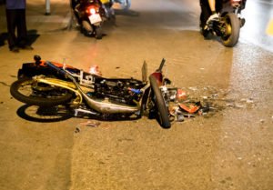 smashed-up motorcycle at night
