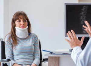 woman with neck injury talking to her doctor