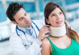 doctor fits a patient for a neck brace