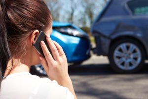 driver calls insurance after car accident