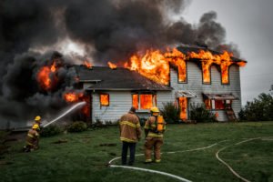 firefighters attempt to put out fire caused by arson