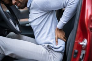 man experiences back pain after car crash