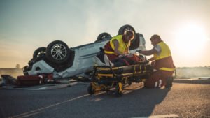 first responders help car accident survivor
