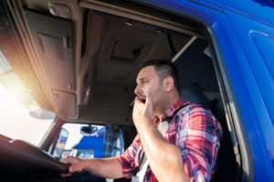 tired truck driver yawning