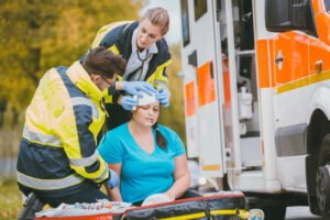 medics tend to a woman with a head injury