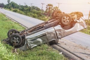 A truck rolled over on the side of a road.