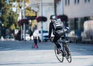 man rides electic bike around city