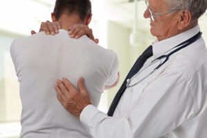 man visits doctor for back pain