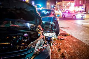 black cars in a crash at night